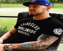 The wrestler is a tattoo freak and has his left hand full of tattoos and one of dollar sign behind his left ear.